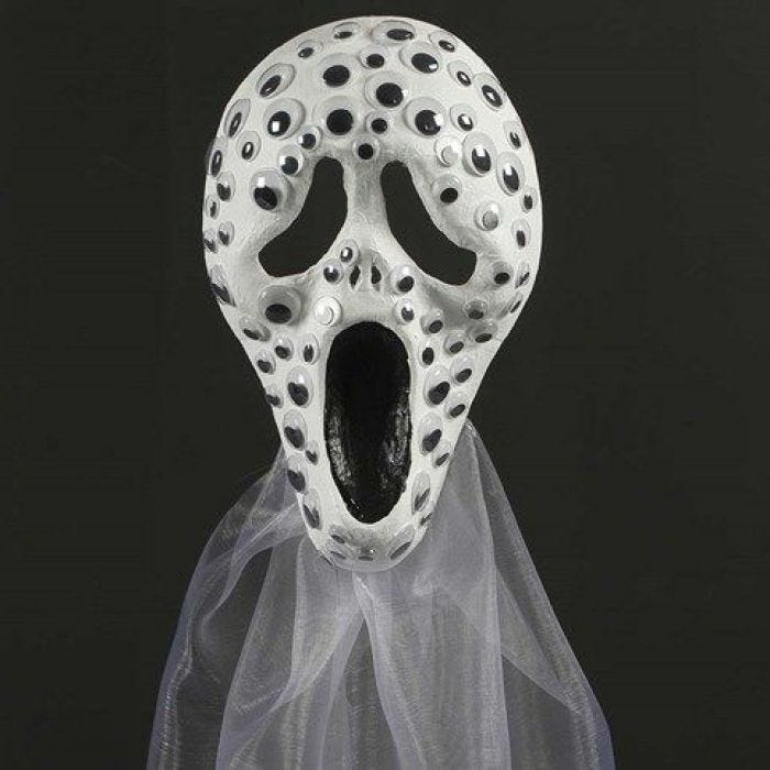 Malt helmaske pyntet med rulleøyne og organza