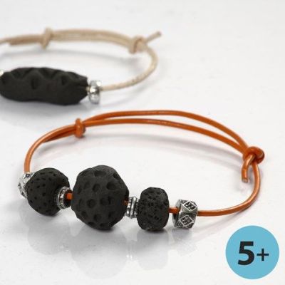 Armb&aring;nd av leireperler, svartbrente p&aring; b&aring;l