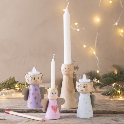 Lysestaker i tre som sprer julestemning