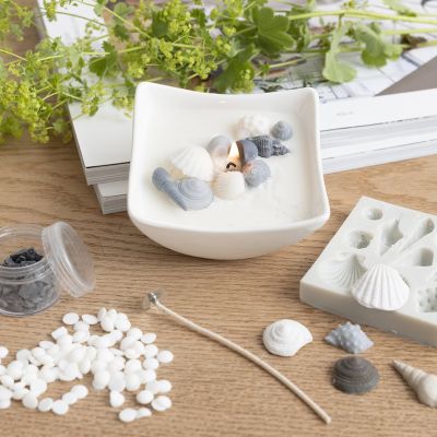 Stearinlys med strandskjell