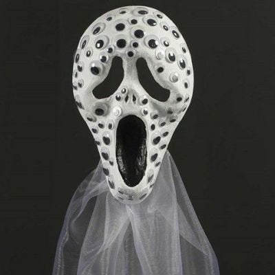 Malt helmaske pyntet med rulleøyne og organza