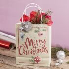 Gavepose med julemotiv pyntet med stjerne, lametta og silkepapir